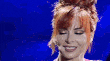 a close up of a woman 's face with red hair