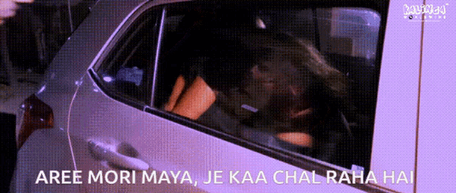 a woman is sitting in the back seat of a car with the words aree mori maya je kaa chal raha hai