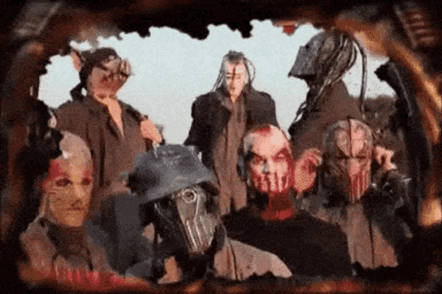 a group of people with masks on their faces are posing for a photo