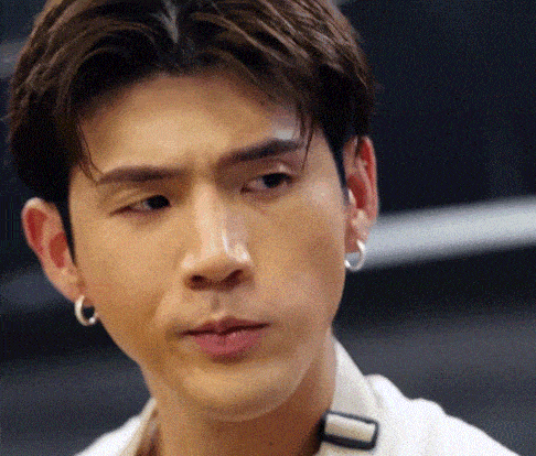 a close up of a man wearing hoop earrings