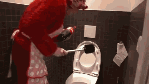 a person in a red costume cleaning a toilet with a plunger