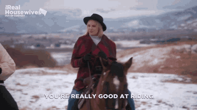 a woman riding a horse with the words " you 're really good at riding " below her