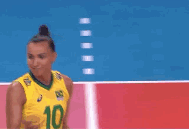 a volleyball player with the number 10 on her jersey is giving a high five to another player .