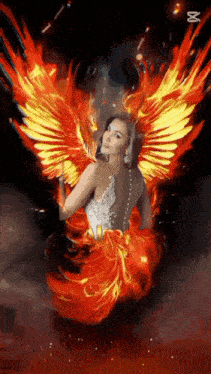 a woman in a white dress is surrounded by flames .
