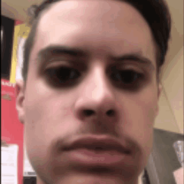 a close up of a man 's face looking at the camera