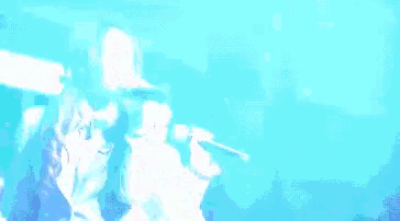 a man in a white shirt is dancing in a crowd with a sign that says ' okinawa ' on it