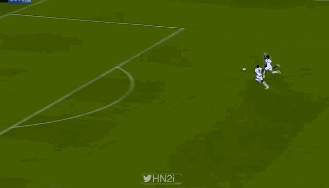 a soccer game is being played on a field with a konami banner on the sidelines