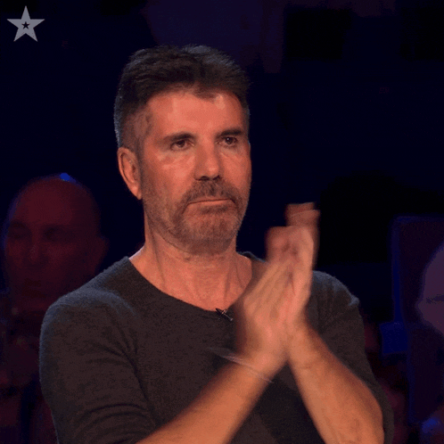 a man with a beard is clapping his hands with a star on his chest