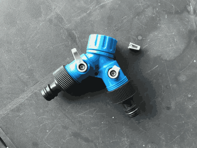 a blue and black hose connector has a screw on it