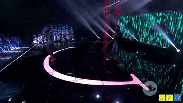 a man singing into a microphone on a stage with a sign that says ' sf ' on it