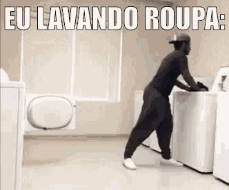 a man is loading clothes into a washing machine in a laundry room .