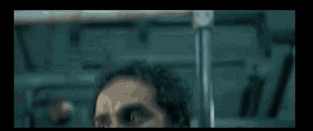a close up of a man 's neck in a dark room with a blurred background