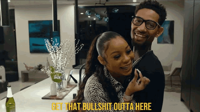 a man and a woman are hugging with the words get that bullshit outta here