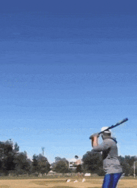 a man is swinging a bat at a ball
