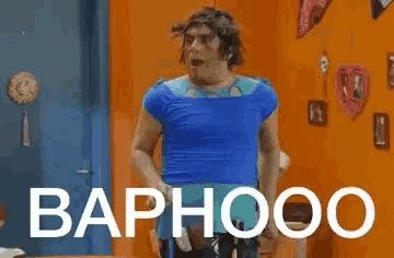a man in a blue shirt is standing in a room with the word baphooo written on it .