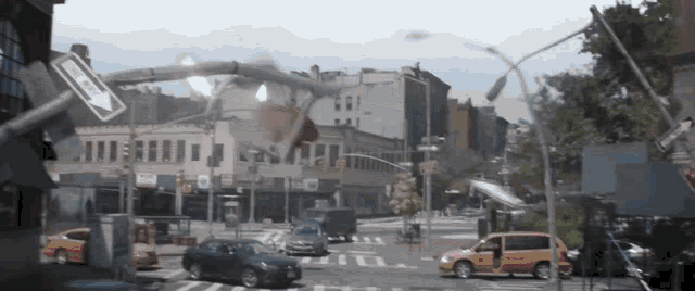 a busy intersection with a one way sign in the foreground