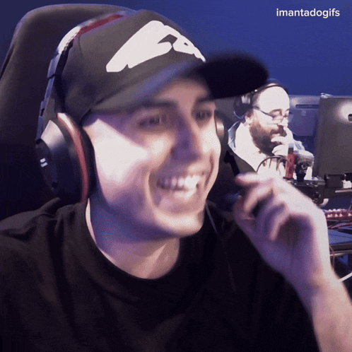 a man wearing headphones and a hat is smiling with the caption imantadogifs below him