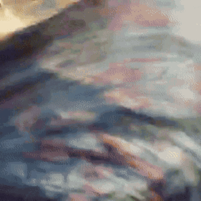 a close up of a painting with a lot of colors and a blurred background