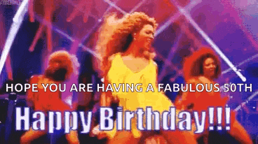 a woman is dancing on a stage with the words `` hope you are having a fabulous 50th happy birthday '' .