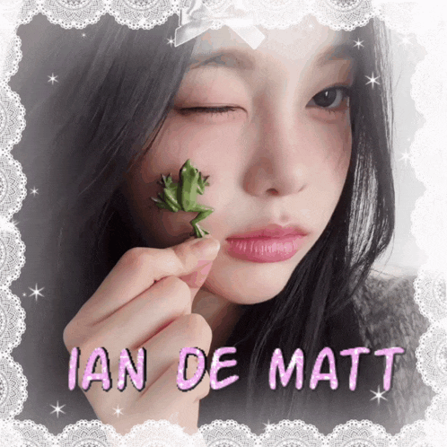 a girl holding a frog in front of her face with the name ian de matt