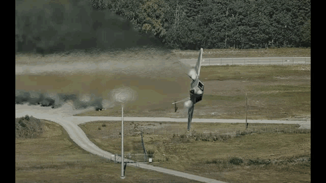a fighter jet is taking off from a runway with smoke coming out of it