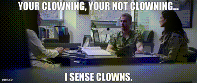 a man sits at a desk with two women and says " your clowning your not clowning .... i sense clowns "
