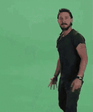 a man is dancing in front of a green screen with the words `` do it '' .