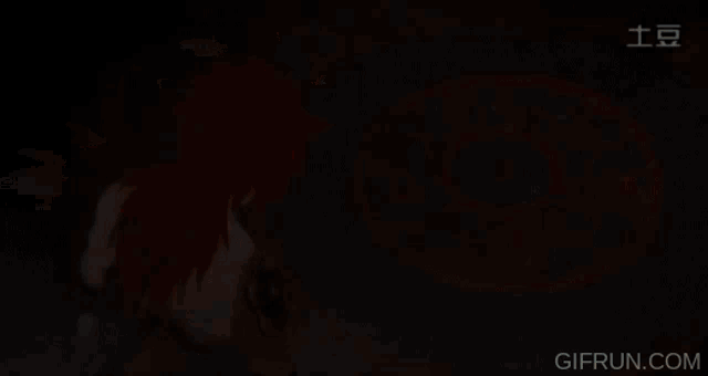 a gif from gifrun.com shows a person with red hair standing in front of a circular pattern