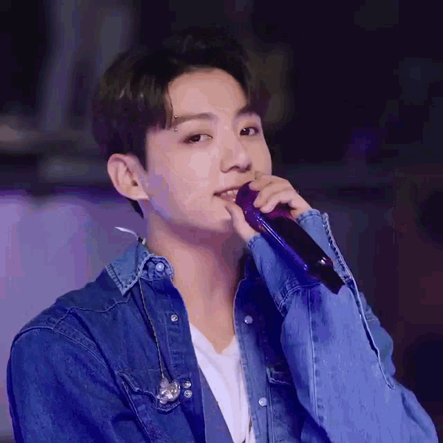 a close up of a person holding a microphone