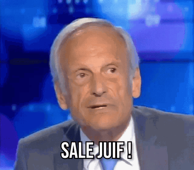 a man in a suit and tie is making a funny face and saying sale juif .