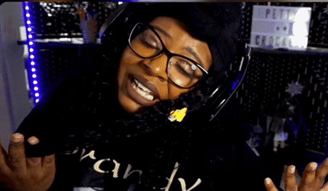 a woman wearing glasses and headphones is eating popcorn in front of a sign that says appetite