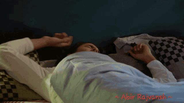 a man is laying in bed with the name abir rajvansh on the bottom right