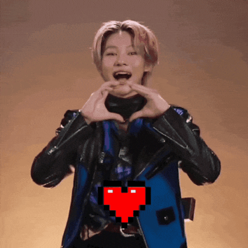 a man making a heart shape with his hands with a pixelated heart behind him