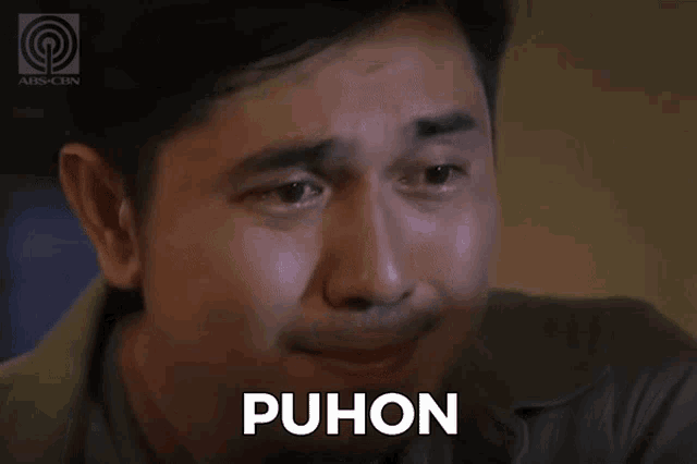 a man with tears running down his face and the word puhon on the bottom
