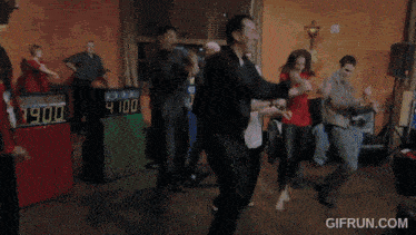 a group of people are dancing in front of a sign that says 4100