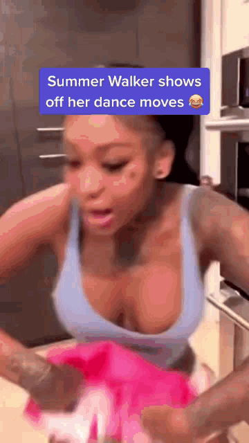a woman in a blue tank top shows off her dance moves with a caption that says summer walker shows off her dance moves