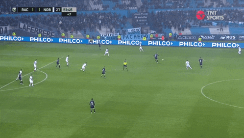 a soccer game is being played in front of a philco ad