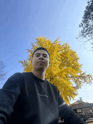 a man wearing a black sweater that says " feel good "