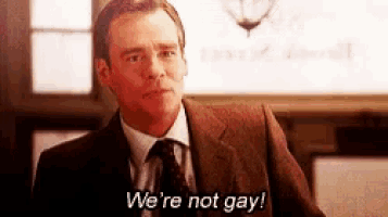a man in a suit and tie is talking about being gay .