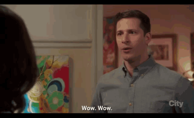 a man in a blue shirt says wow wow in front of a woman