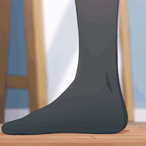 a close up of a person 's foot with a black sock on