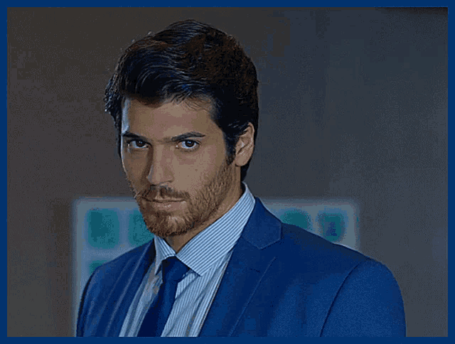 a man with a beard wearing a suit and tie