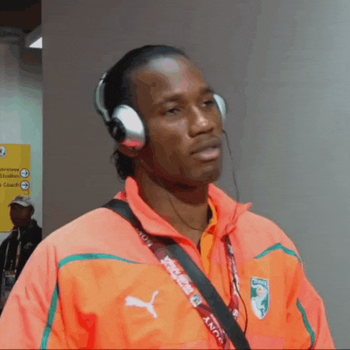 a man wearing headphones and a lanyard that says sony on it