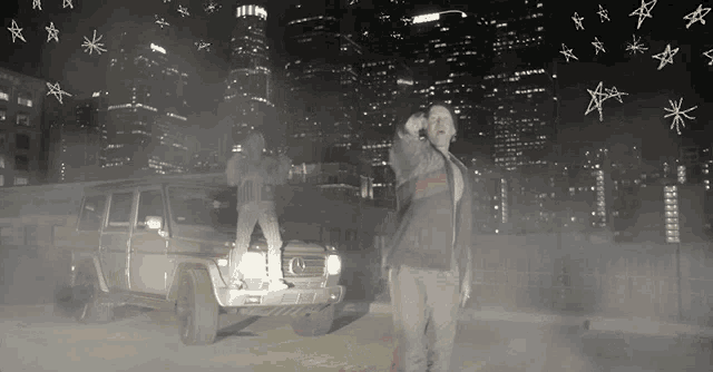 a man in a gucci jacket stands in front of a mercedes suv