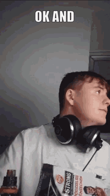 a young man wearing headphones and a shirt that says strong