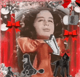 a little girl in a red dress is surrounded by dogs and a cat .