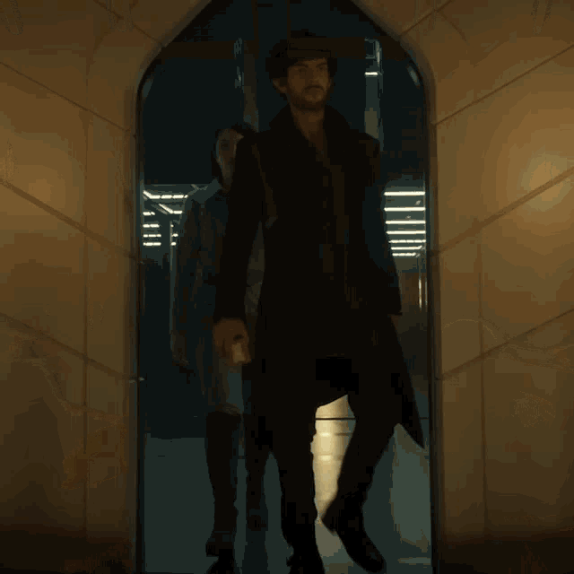 a man and a woman are standing in a room with candles