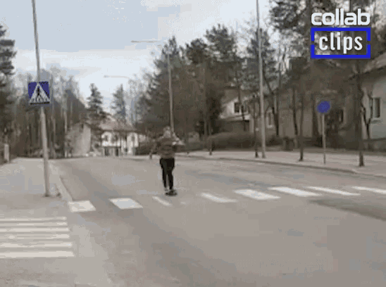 a person is riding a skateboard down a street in a city .