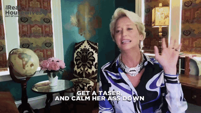 a woman says get a taser and calm her ass down in front of a globe