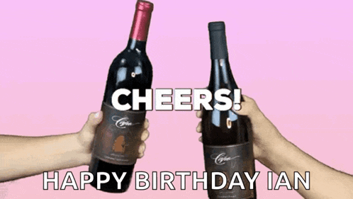 two bottles of wine are being held in front of a pink background
